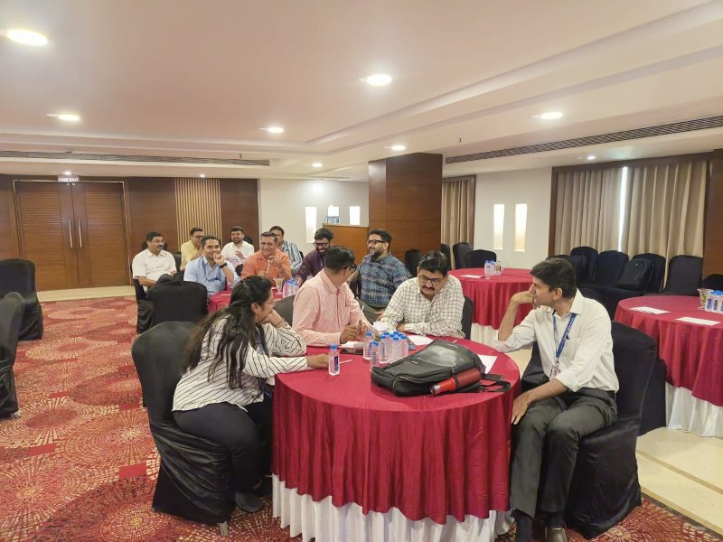 Teams working through activities at their tables